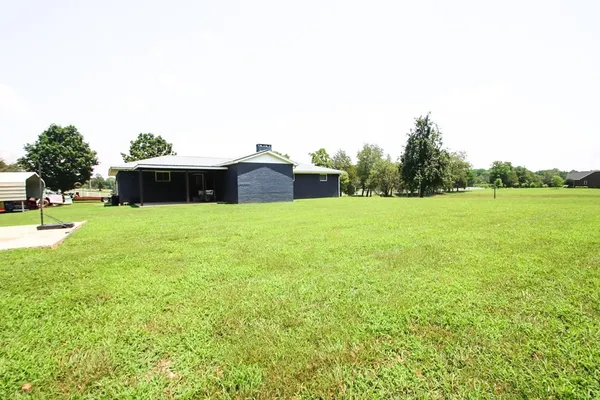 a view of a green yard with a house