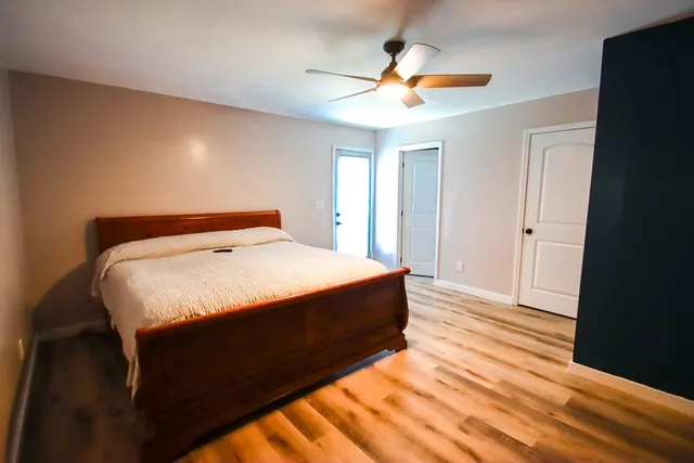 a bedroom with a bed and a chandelier