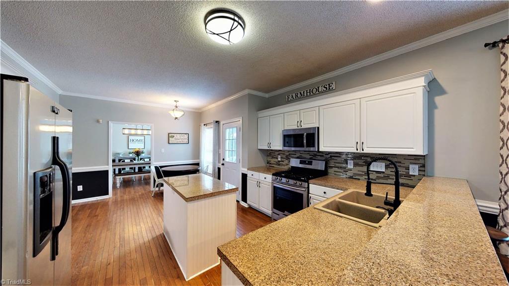 4129 Carroll Ridge Court High Point, NC 27265 - Photo 12 of 30 Another view of kitchen and dining. Bar makes a great place for working from home, homework or casual meals.