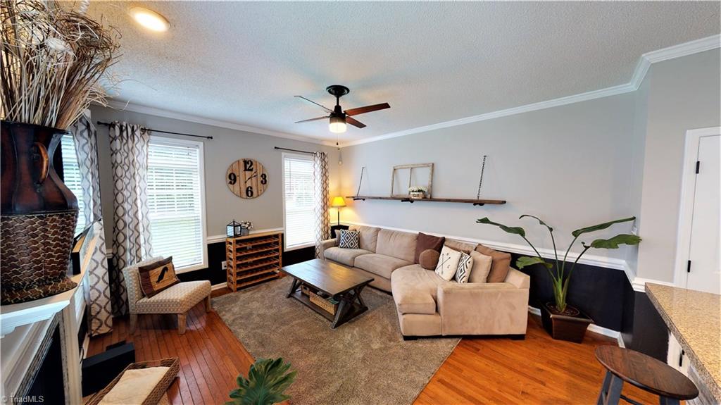 4129 Carroll Ridge Court High Point, NC 27265 - Photo 13 of 30 View into den shows hardwoods, ceiling fan and natural light from multiple windows.