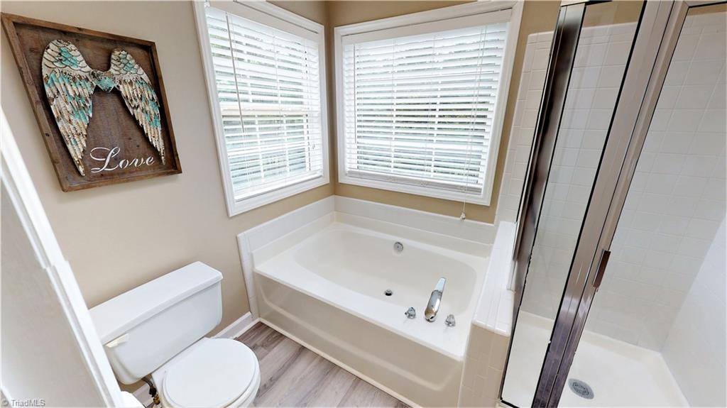 4129 Carroll Ridge Court High Point, NC 27265 - Photo 22 of 30 New LPV flooring in master bath. Windows and skylight are a huge plus, as well as separate tub and shower.