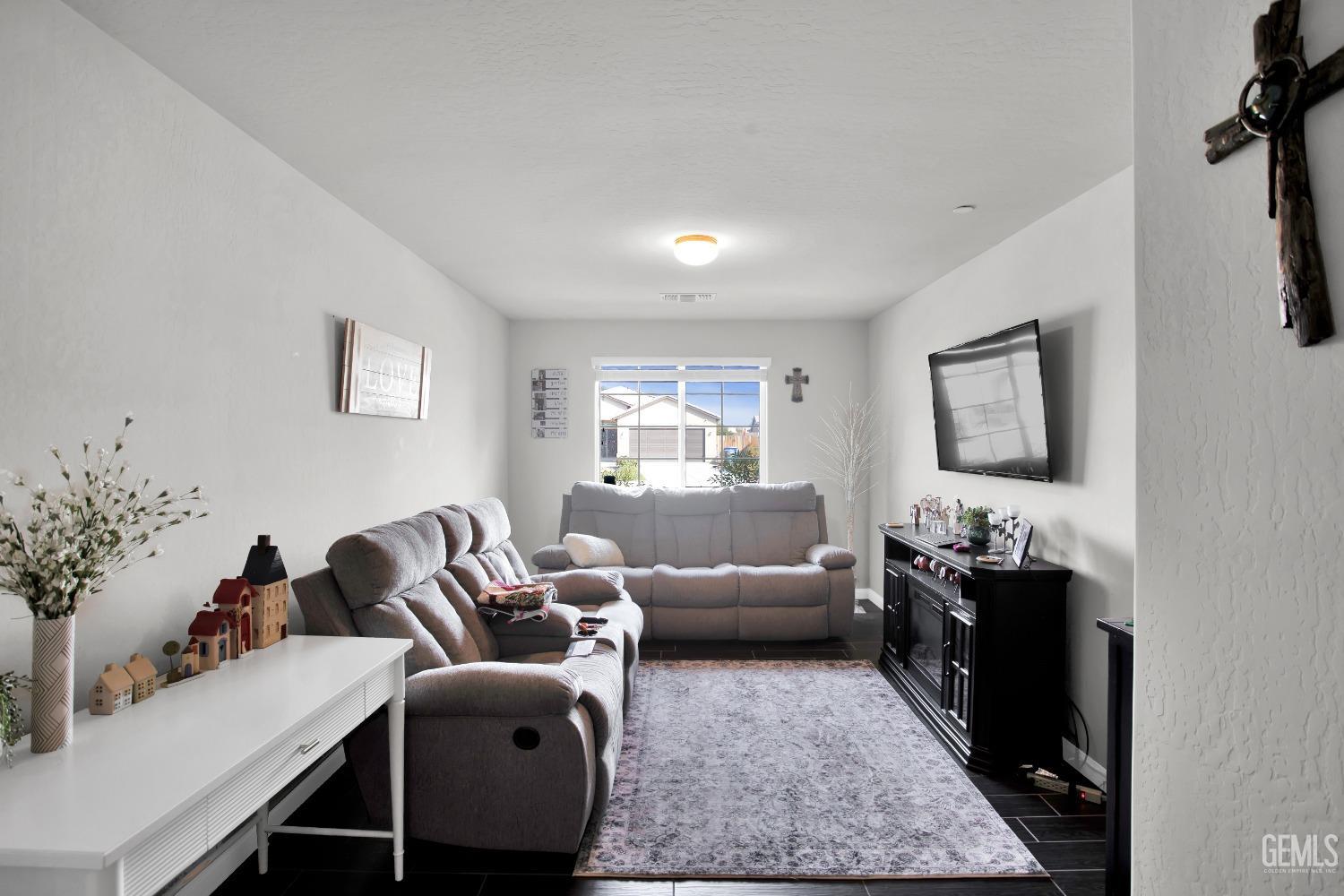 Undisclosed Address Bakersfield, CA 93311 - Photo 14 of 22 a living room with furniture potted plant and a window