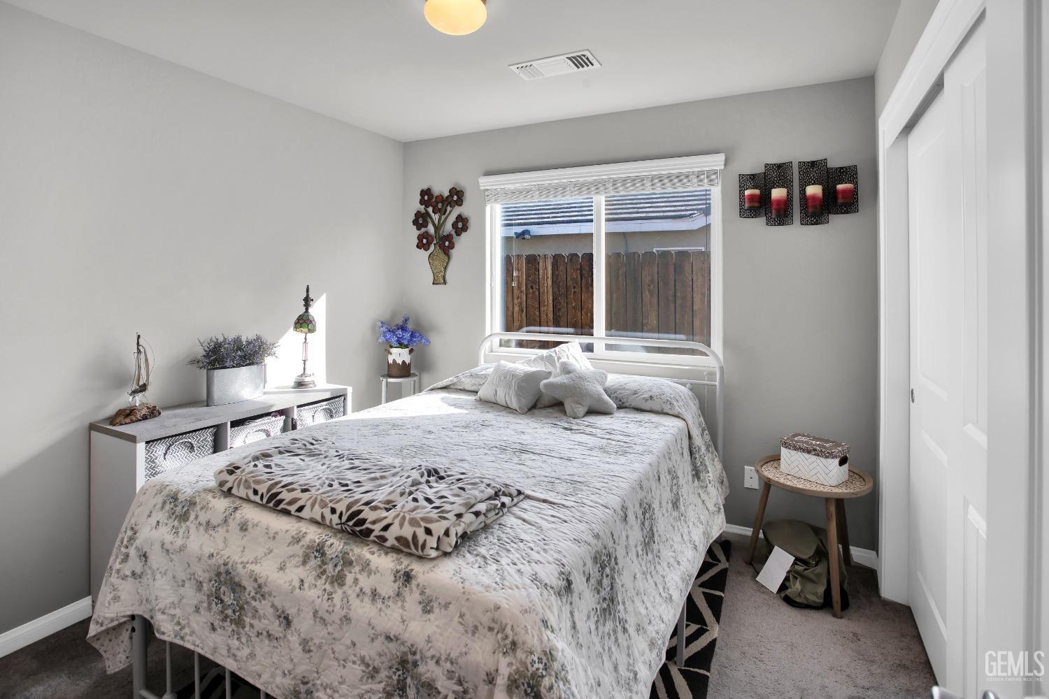 Undisclosed Address Bakersfield, CA 93311 - Photo 17 of 22 a bedroom with a bed and a window