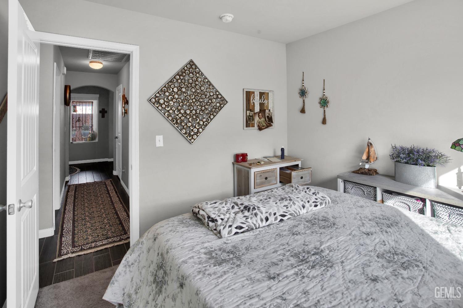 Undisclosed Address Bakersfield, CA 93311 - Photo 18 of 22 a bedroom with a bed and a dresser in it