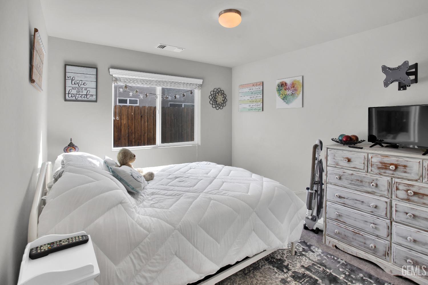 Undisclosed Address Bakersfield, CA 93311 - Photo 19 of 22 a bedroom with a bed and a flat screen tv