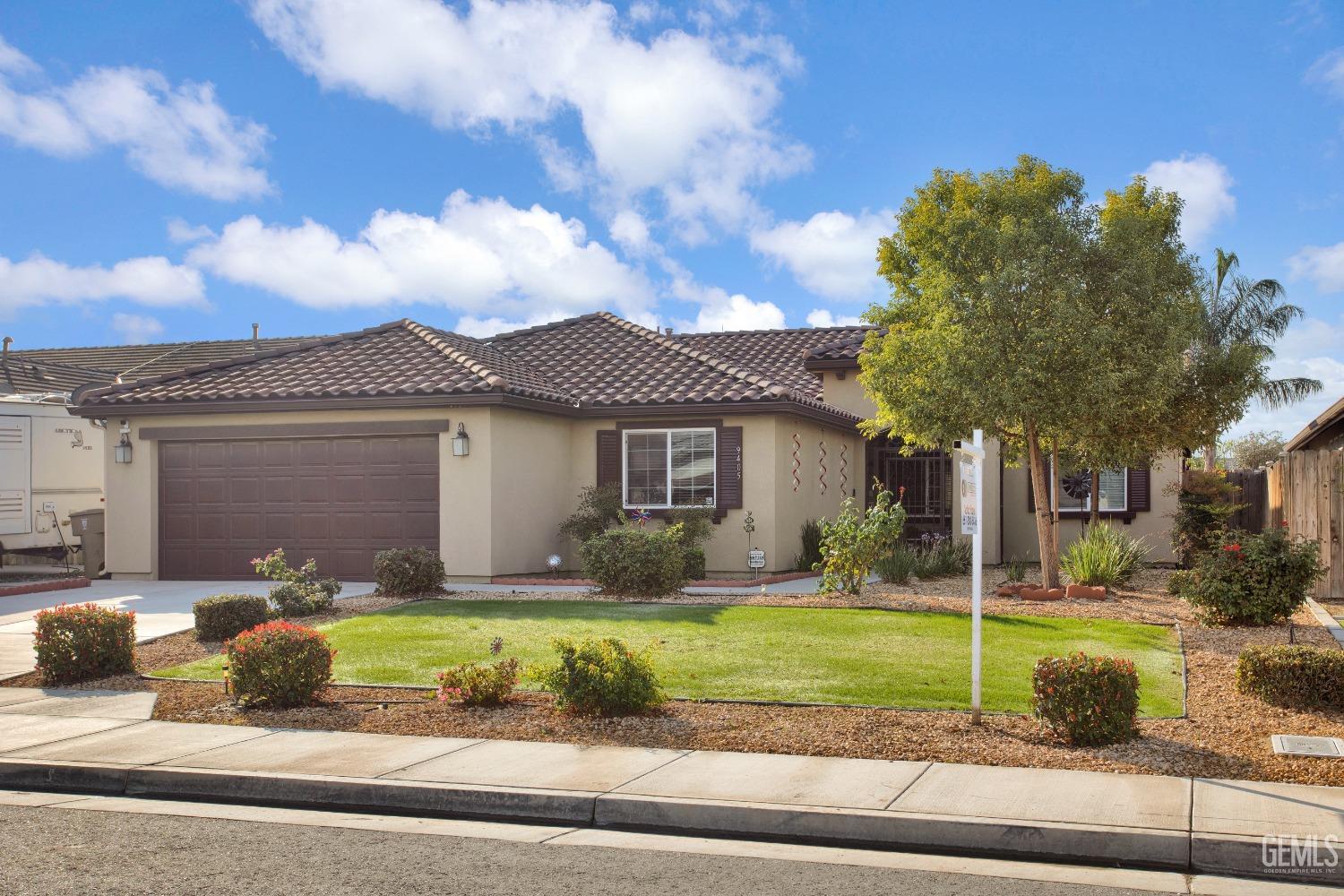 Undisclosed Address Bakersfield, CA 93311 - Photo 5 of 22 a front view of a house with a yard