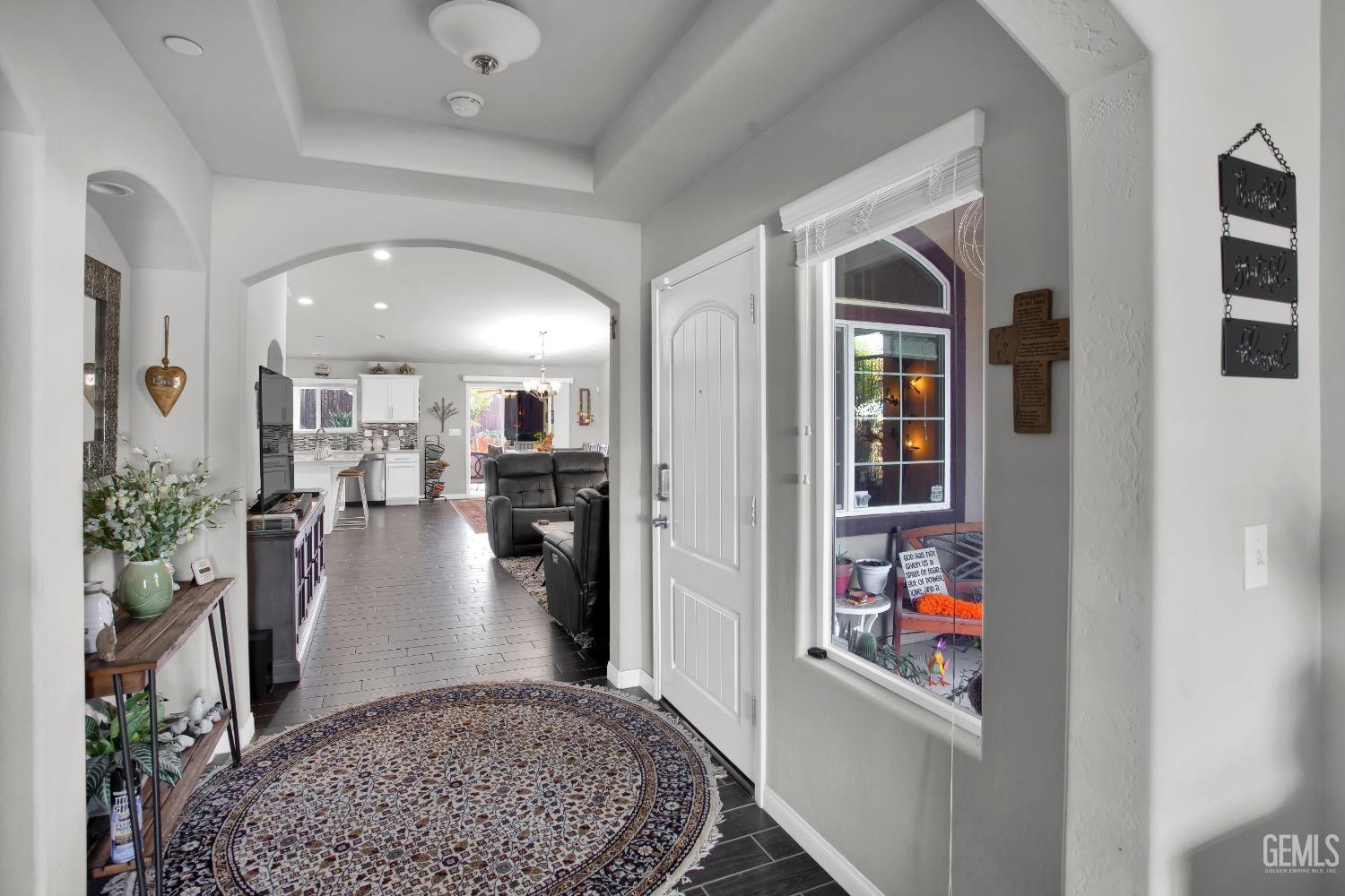 Undisclosed Address Bakersfield, CA 93311 - Photo 6 of 22 a view of a hallway with living room and dining room