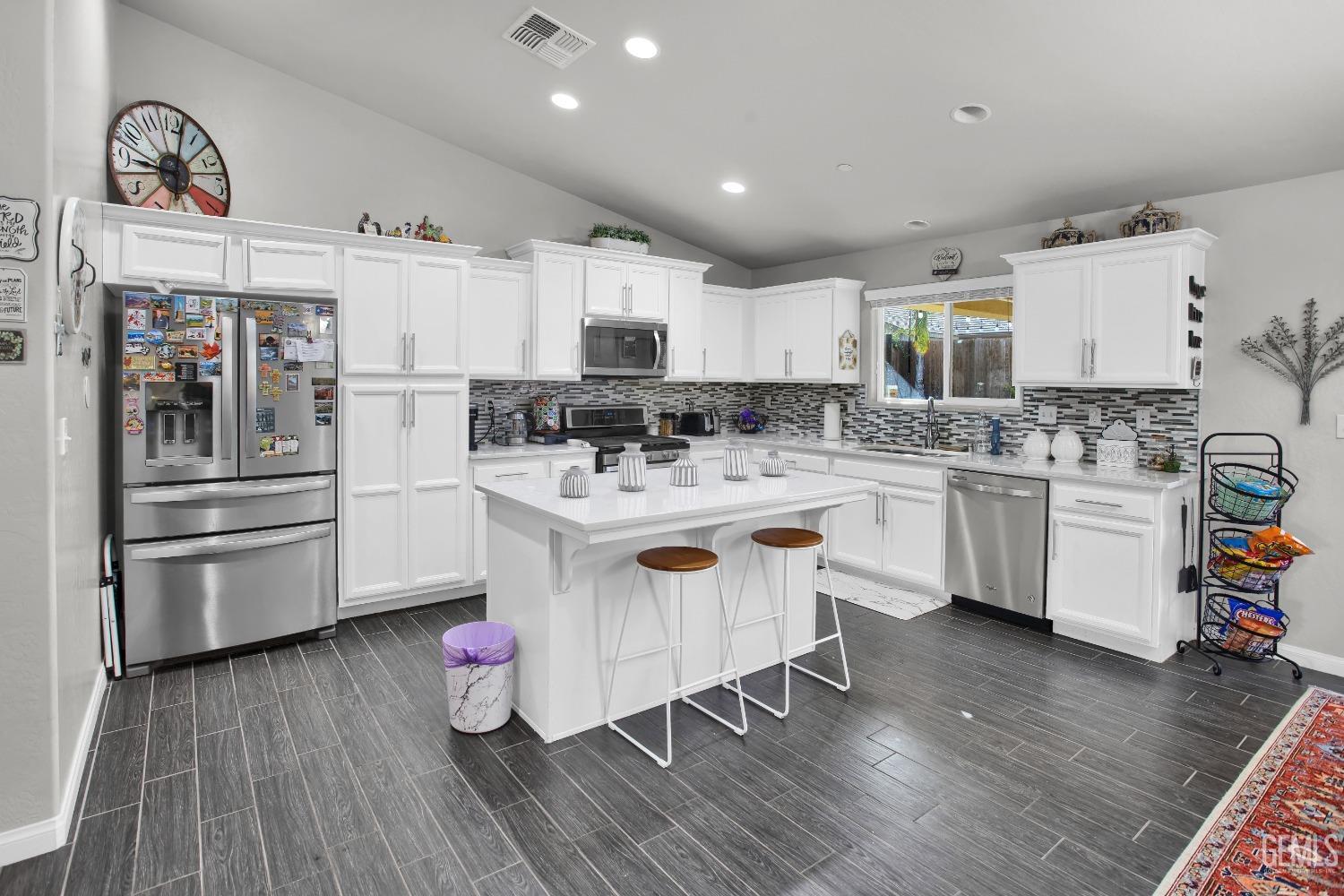 Undisclosed Address Bakersfield, CA 93311 - Photo 7 of 22 a kitchen with stainless steel appliances a sink cabinets and wooden floor