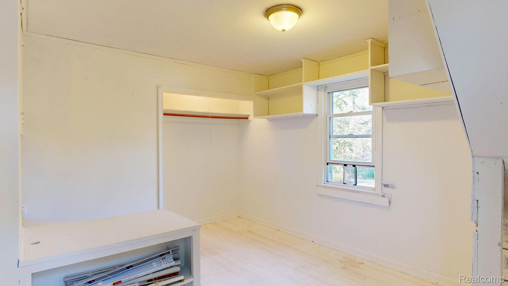 4455 North Genesee Road Flint, MI 48506 - Photo 16 of 47 Walk in closet featuring light wood finished floors