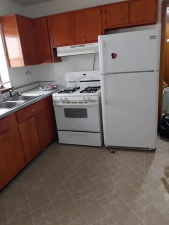 a white refrigerator freezer sitting inside of a kitchen