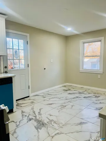 a view of a livingroom with wooden floor and a window
