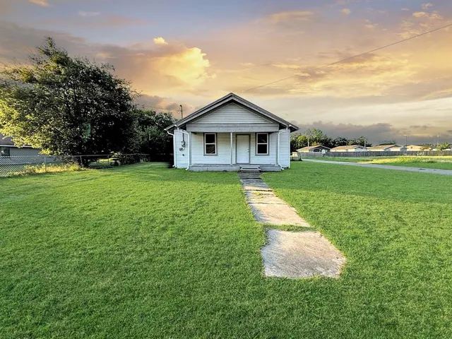 a view of a house with a yard and a garden