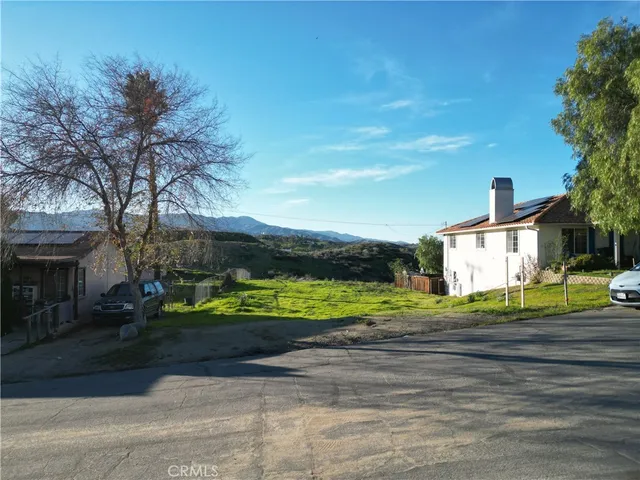 a view of a big house in a big yard with large trees