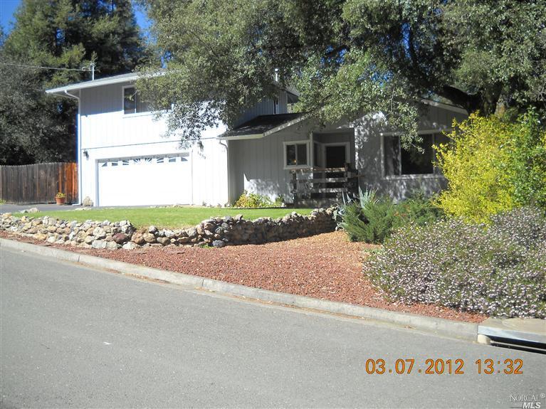 1650 Crane Road Ukiah, CA 95482 - Photo 1 of 1 a front view of a house with a garden and trees