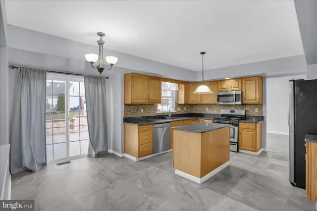 an empty room with windows and glass door