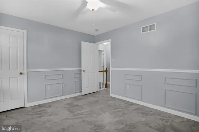 a bathroom with a sink toilet vanity and window
