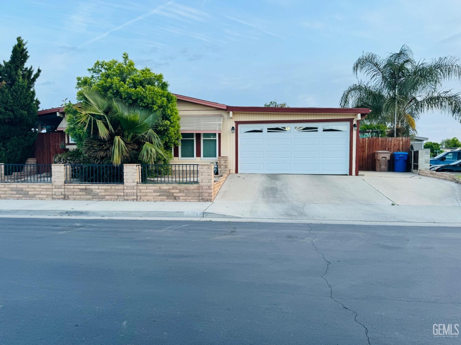 a view of a house with a yard and potted plants