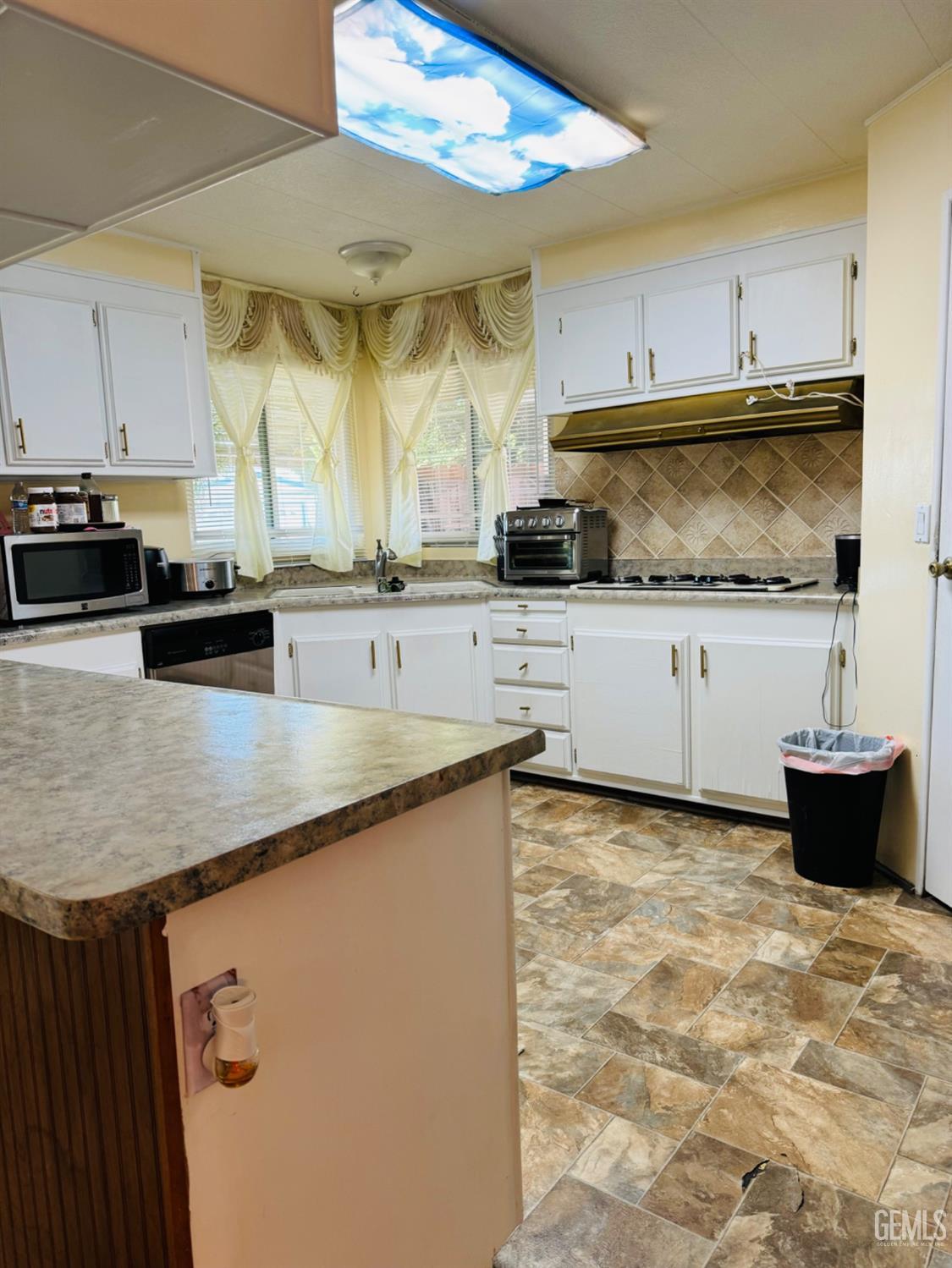 Undisclosed Address Bakersfield, CA 93313 - Photo 16 of 32 a kitchen with stainless steel appliances granite countertop a sink a stove and cabinets