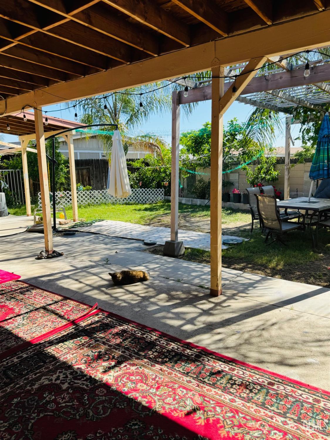 Undisclosed Address Bakersfield, CA 93313 - Photo 29 of 32 a view of a patio with table and chairs under an umbrella