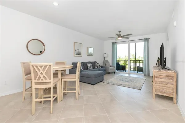 a bedroom with furniture and a floor to ceiling window