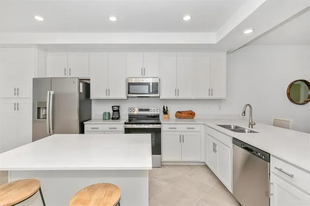a living room with furniture a flat screen tv and a large window