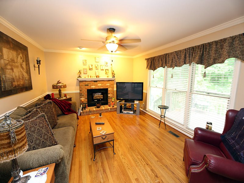 13101 Meadow Ridge Drive Rougemont, NC 27572 - Photo 3 of 12 a living room with furniture a flat screen tv and a large window