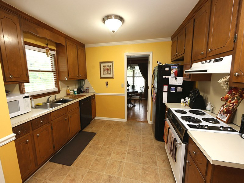 13101 Meadow Ridge Drive Rougemont, NC 27572 - Photo 5 of 12 a kitchen with stainless steel appliances a sink stove and cabinets