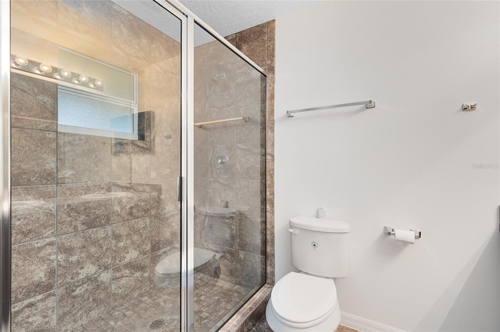 2717 Shelby Ruth Place St. Cloud, FL 34769 - Photo 20 of 31 a bathroom with a toilet and a shower