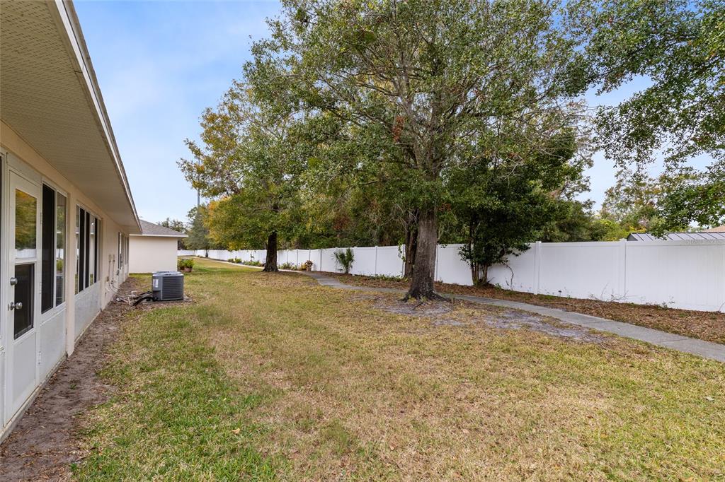 2717 Shelby Ruth Place St. Cloud, FL 34769 - Photo 25 of 31 a view of a yard with basketball court