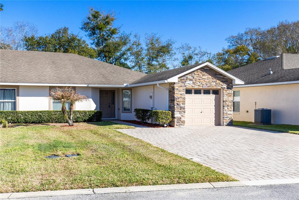 2717 Shelby Ruth Place St. Cloud, FL 34769 - Photo 3 of 31 a front view of a house with a yard