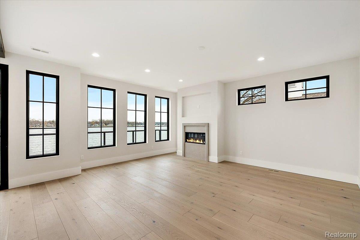 13459 Haddon Street Fenton, MI 48430 - Photo 31 of 84 fireplace, plenty of natural light, light wood finished floors, and recessed lighting