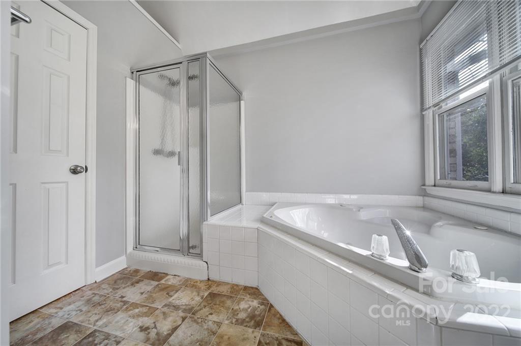 584 Cranborne Chase Fort Mill, SC 29708 - Photo 20 of 36 a bathroom with a tub a sink and a window