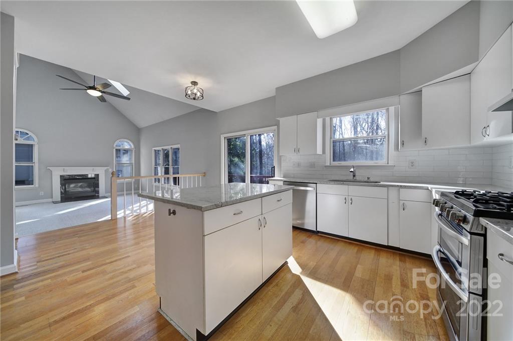 584 Cranborne Chase Fort Mill, SC 29708 - Photo 5 of 36 a kitchen with granite countertop a stove top oven sink and cabinets