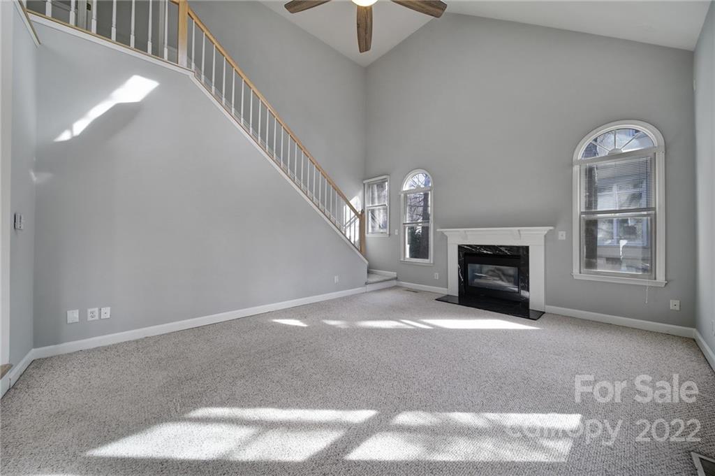 584 Cranborne Chase Fort Mill, SC 29708 - Photo 9 of 36 a view of an empty room with chandelier fan and fireplace