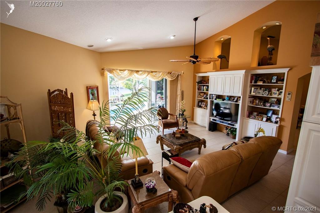 1946 Northwest Fork Road Stuart, FL 34994 - Photo 13 of 32 a living room with furniture a rug and a flat screen tv