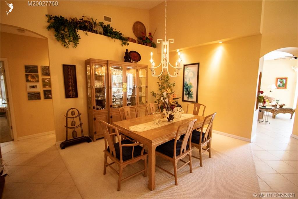 1946 Northwest Fork Road Stuart, FL 34994 - Photo 14 of 32 a dining room with furniture and a chandelier