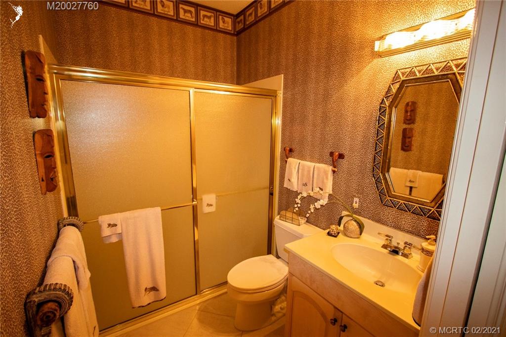 1946 Northwest Fork Road Stuart, FL 34994 - Photo 30 of 32 a bathroom with a granite countertop sink toilet and shower