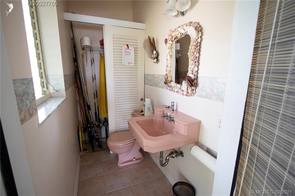 1946 Northwest Fork Road Stuart, FL 34994 - Photo 32 of 32 a bathroom with sink and mirror