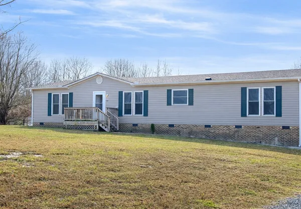 a view of a house with a swimming pool and a yard