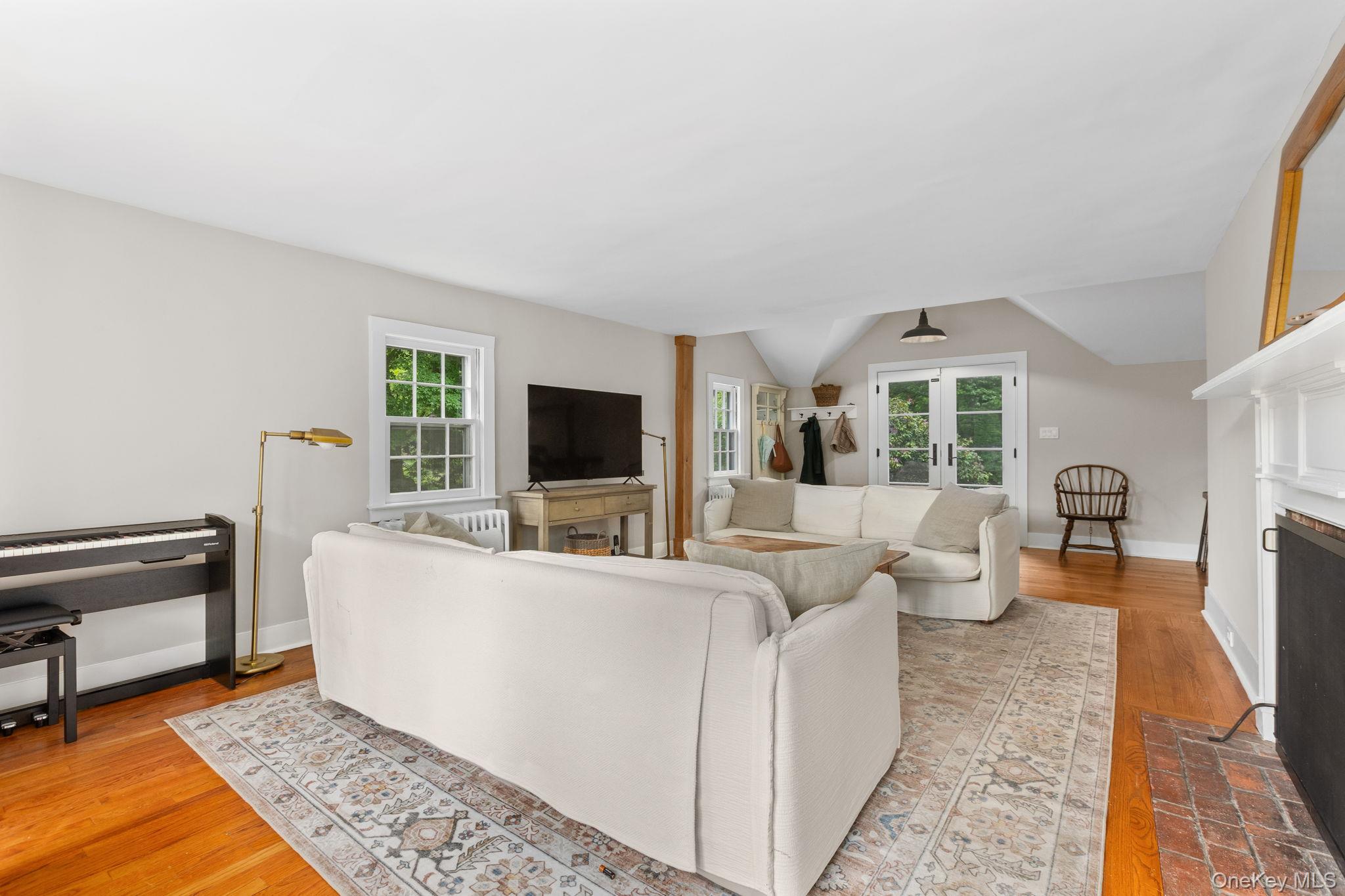 23 Pound Ridge Road Pound Ridge, NY 10576 - Photo 6 of 40 a living room with furniture and a flat screen tv
