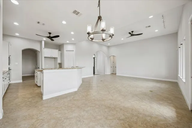 a view of a kitchen with a sink and stainless steel appliances