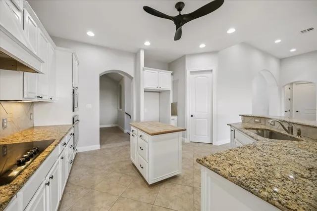 a kitchen with stainless steel appliances granite countertop a sink and a stove