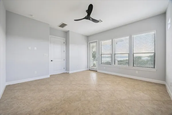 a view of an empty room with windows