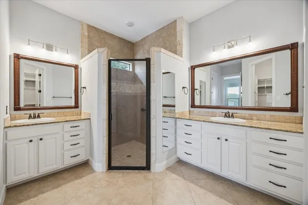 a spacious bathroom with a granite countertop sink mirror and