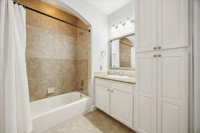 a bathroom with a bathtub a sink and a mirror