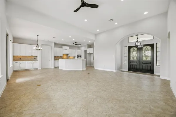 an empty room with cabinet and mirrors