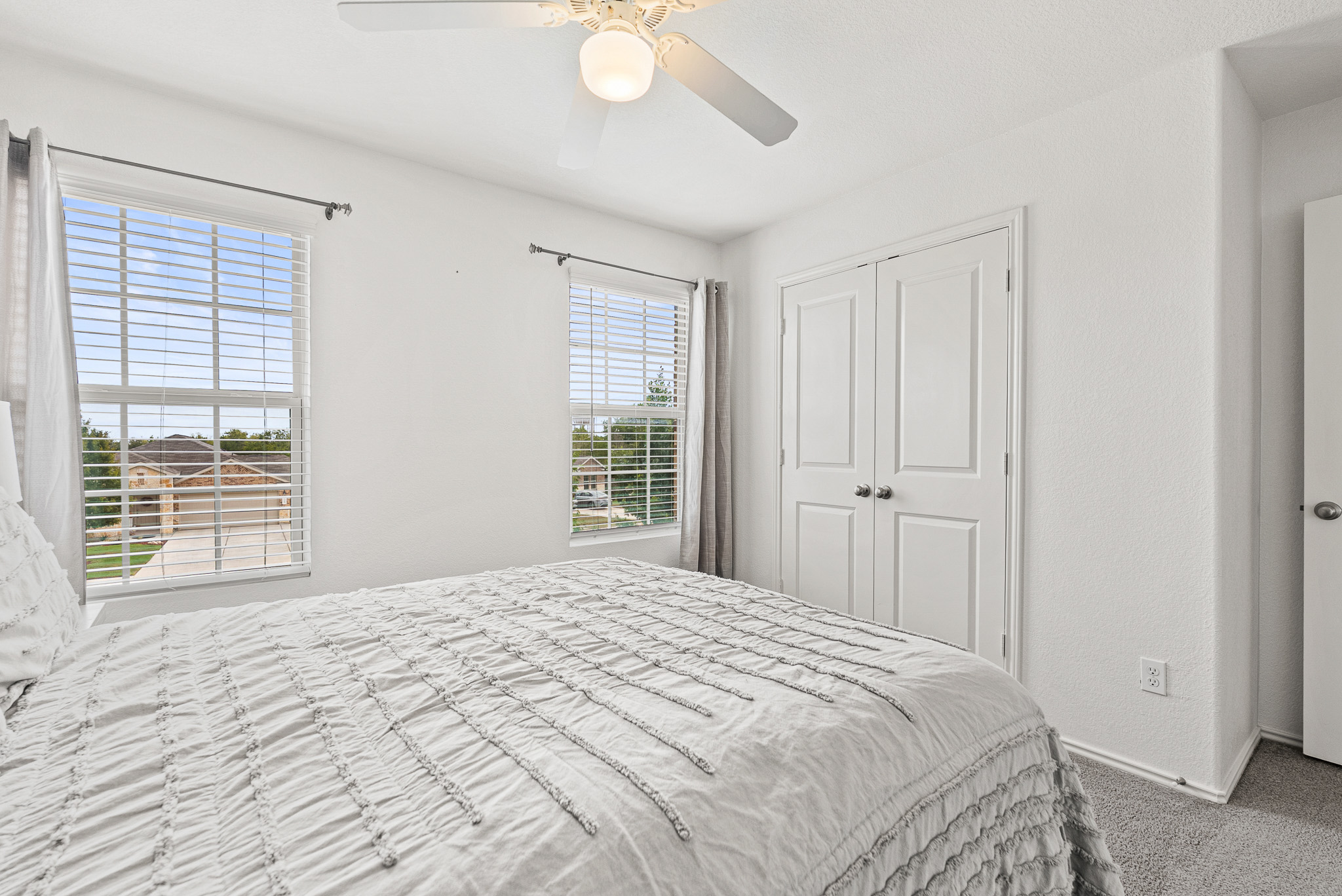 136 Copper Lane Kyle, TX 78640 - Photo 24 of 33 Carpeted bedroom featuring ceiling fan and a closet