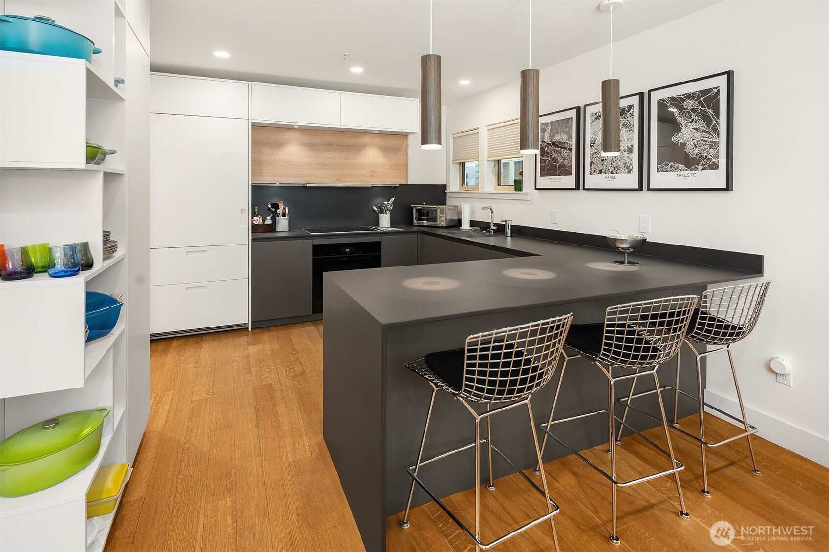 107 23rd Avenue, Unit A Seattle, WA 98122 - Photo 7 of 29 a kitchen with stainless steel appliances kitchen island granite countertop a stove a sink and a microwave