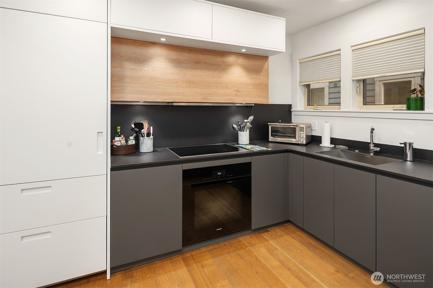 107 23rd Avenue, Unit A Seattle, WA 98122 - Photo 9 of 29 a kitchen with a sink cabinets and appliances