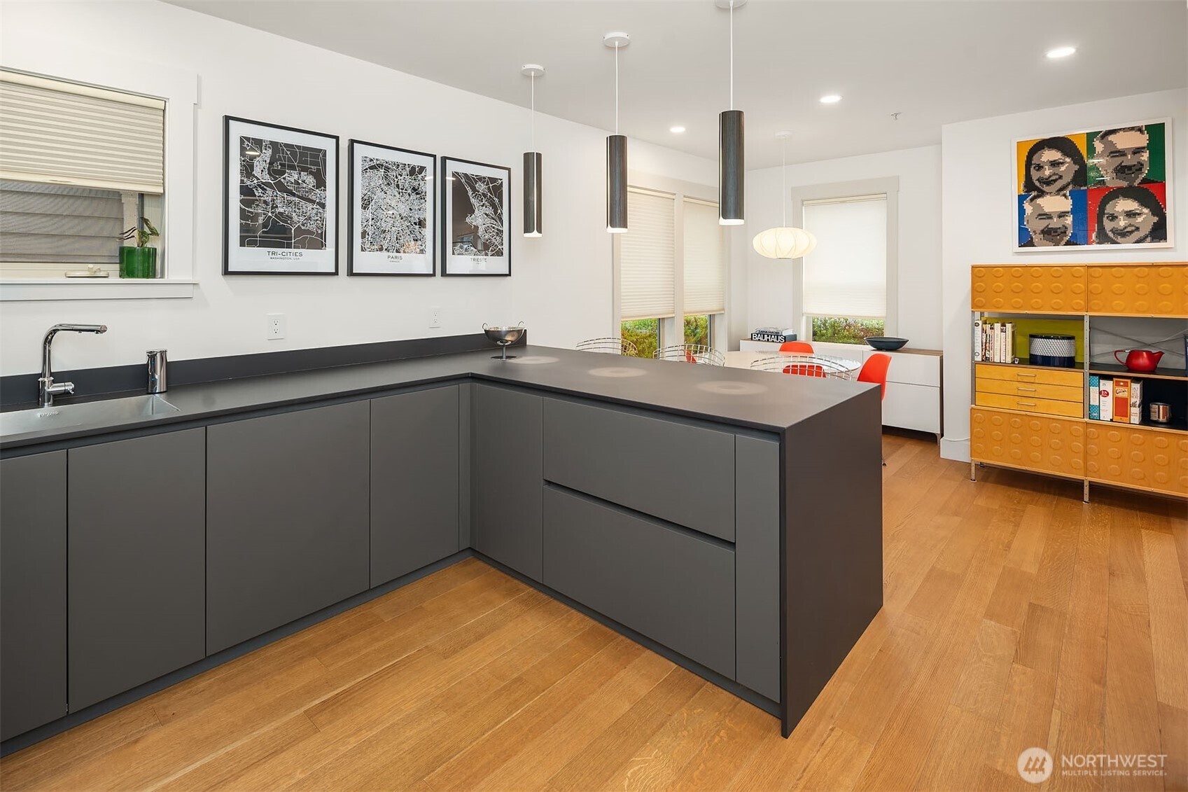 107 23rd Avenue, Unit A Seattle, WA 98122 - Photo 10 of 29 a kitchen with stainless steel appliances granite countertop a sink stove and wooden floor